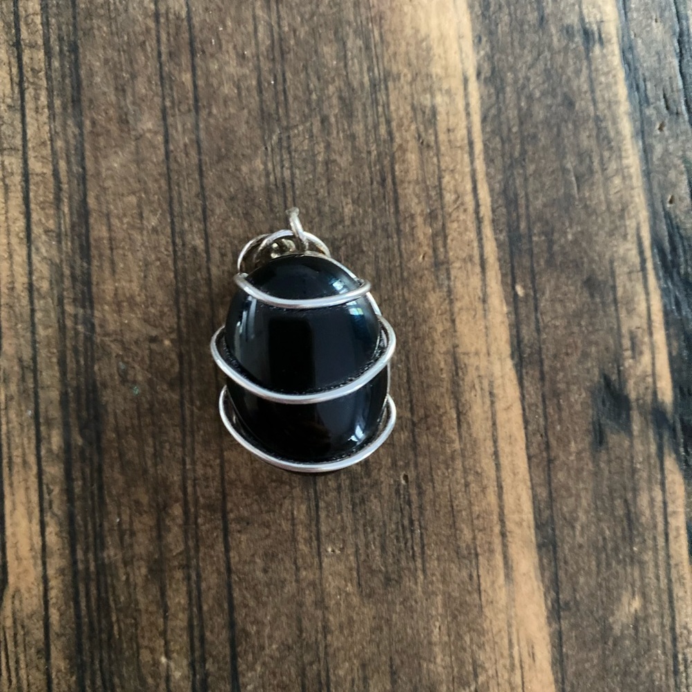 Wire wrapped tumbled black stone pendant